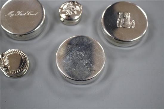 Six modern silver tooth fairy circular boxes, including two My First Curl boxes and one surmounted with a steam engine,